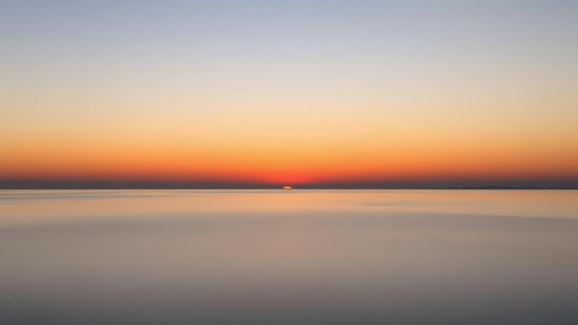 Calm sunrise over still water, symbolizing a hopeful new beginning